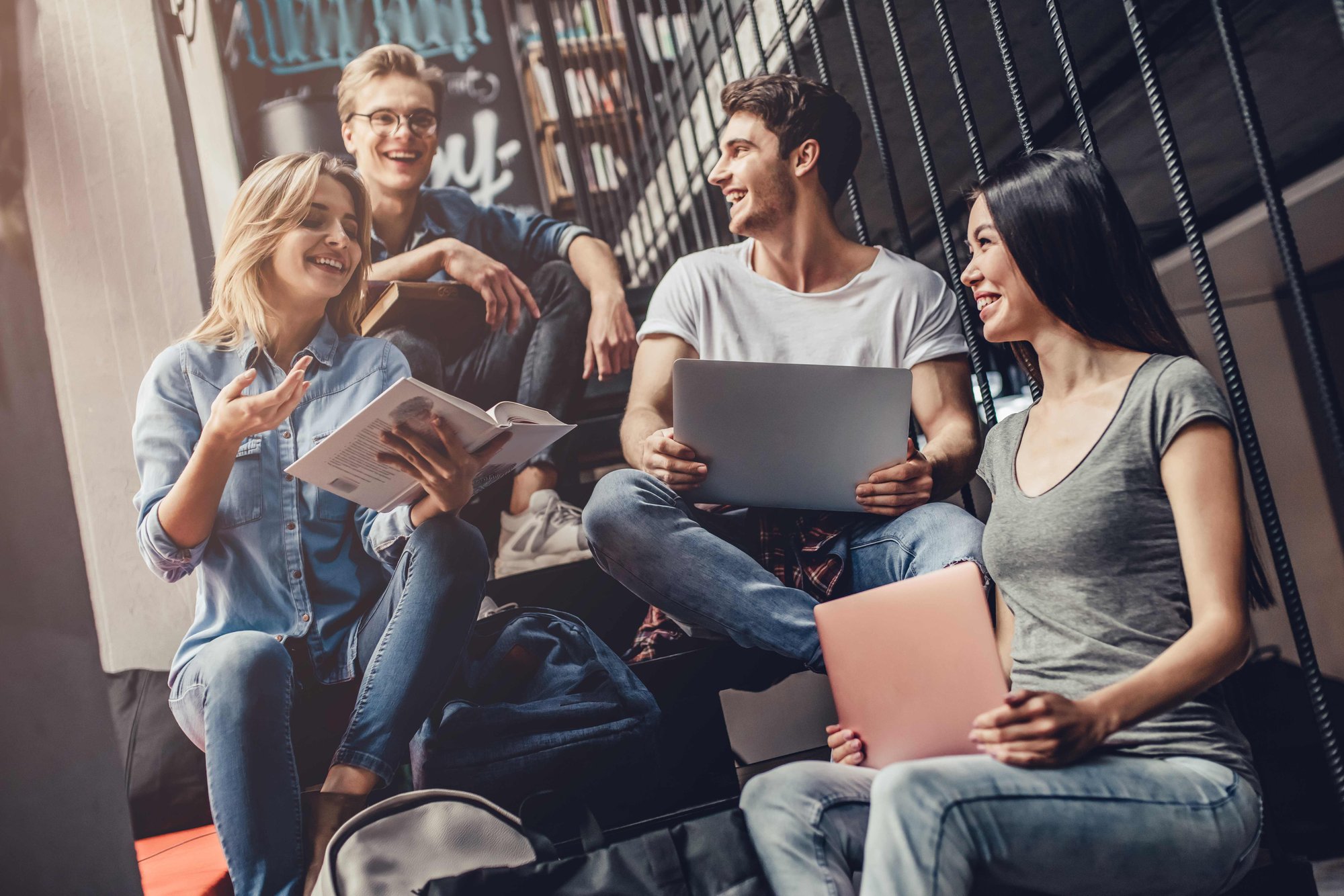 Student group sitting in stairwell with studies