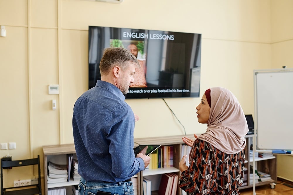 woman-telling-something-to-teacher-2025-03-16-03-17-40-utc 1000px