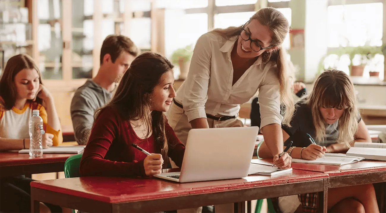 Tutor advising student on requested study materials in classroom_1300